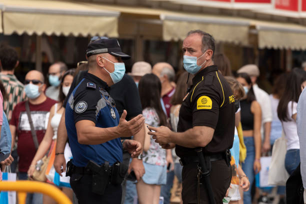 Madrid, Spain - Sep 11, 2021: A Madrid municipal police officer talks to a private security guard, 80th Madrid book fair