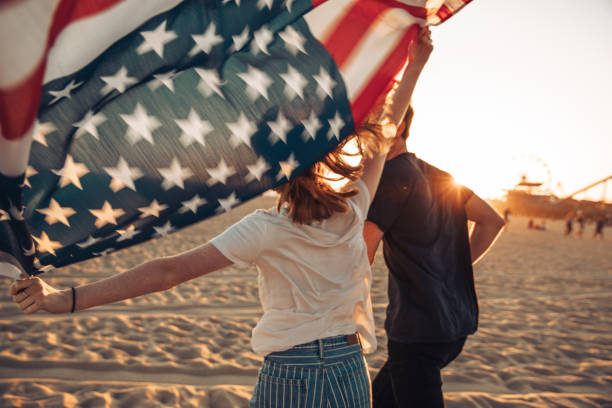 istock Beautiful young couple by the beach 1340865910
