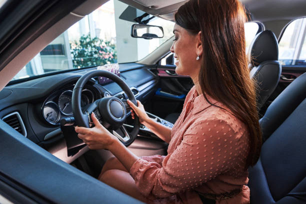 istock Female driver getting used to the new car 1340867624