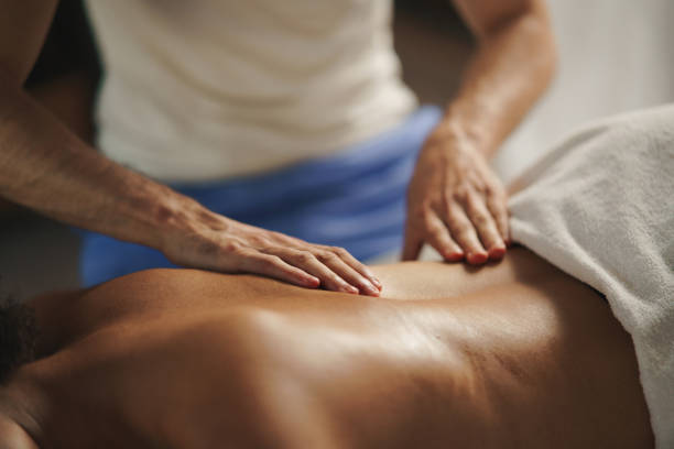istock Unrecognizable young woman having relaxing back massage at the spa. 1340870675