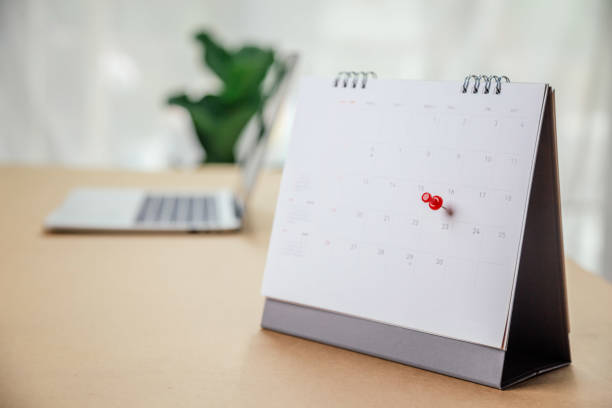 istock Calendar desk place on the table. Desktop Calender for Planner to plan agenda, timetable, appointment, organization, management each date, month, and year on wooden office table. Calendar Concept. 1340870975