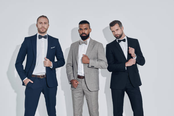 istock Three handsome young men in suits and bowties looking at camera 1340871133