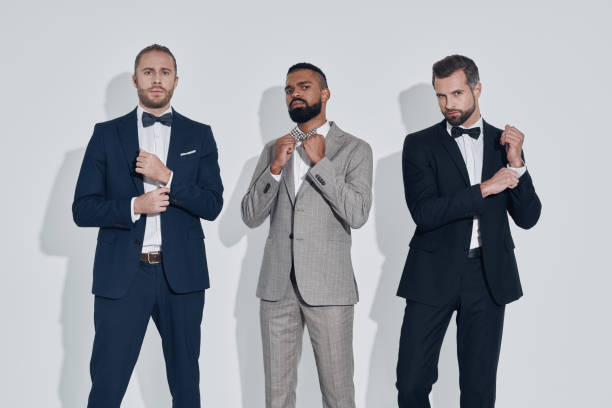 istock Three handsome young men in suits and bowties looking at camera 1340871145