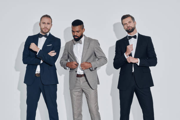 istock Three handsome young men in suits and bowties looking at camera 1340871146