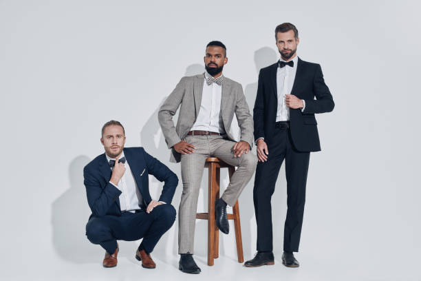 istock Three handsome young men in suits and bowties looking at camera 1340871148