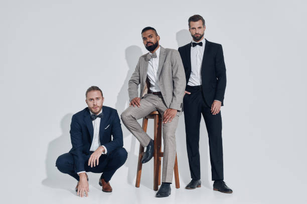 istock Three handsome young men in suits and bowties looking at camera 1340871149