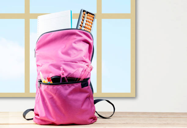 istock Backpack with book and stationary on wooden table 1340871270