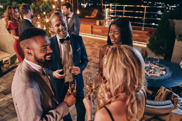 istock Group of people in formalwear communicating and smiling 1340871443