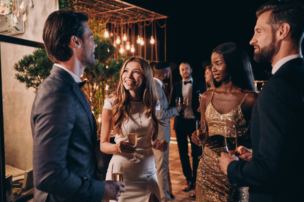 istock Group of people in formalwear communicating and smiling 1340871449