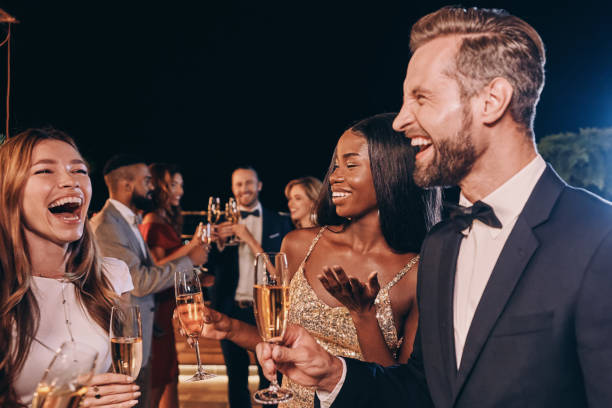 istock Group of beautiful people in formalwear communicating and smiling 1340871994