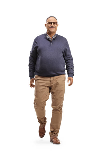 istock Mature smiling man walking towards camera 1340872596