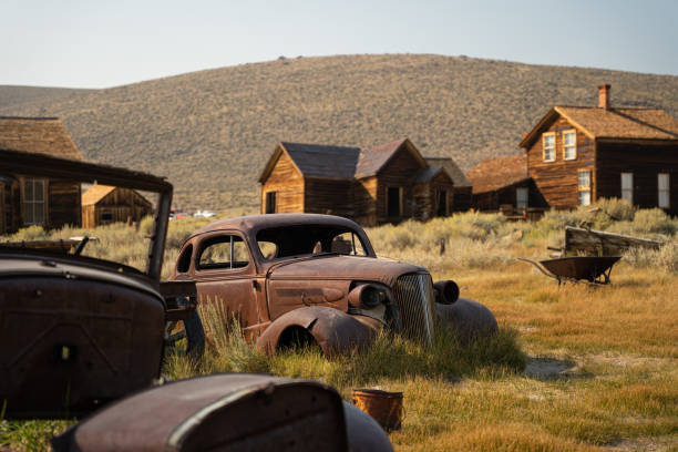 Classic cars in an automotive graveyard of California’s famous Bodie ghost town (1859-1942).