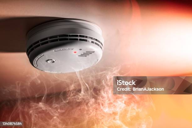 Smoke Detector And Interlinked Fire Alarm In Action Background Stock Photo - Download Image Now