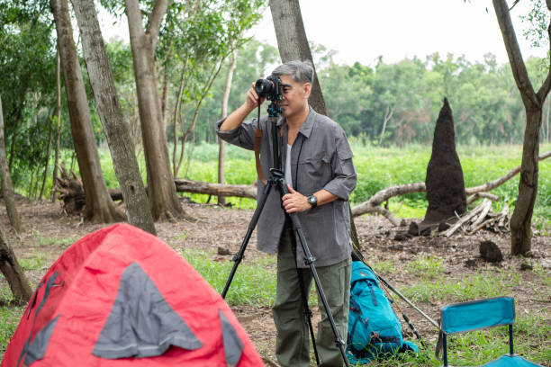 istock Senior photographer hiking in the forest 1340875533
