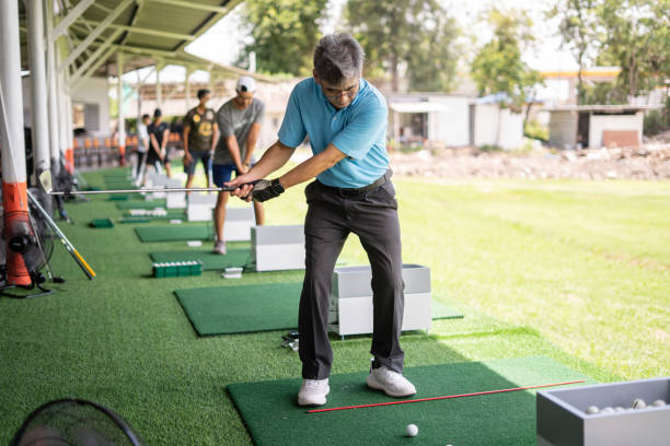 istock active senior man golfer teeing off and swing his diver golf club at golf driving range 1340875841