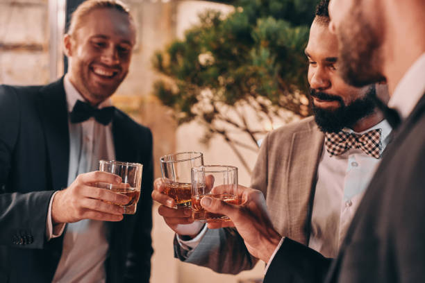 istock Close-up of three well-dressed men drinking whiskey and communicating 1340877340