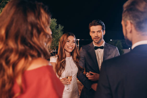 istock Group of people in formalwear communicating and smiling 1340877382
