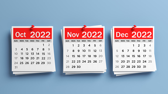 Red and white-colored 2022 October, November, December calendar pages. On blue-colored background. Horizontal composition with copy space. Isolated with clipping path.