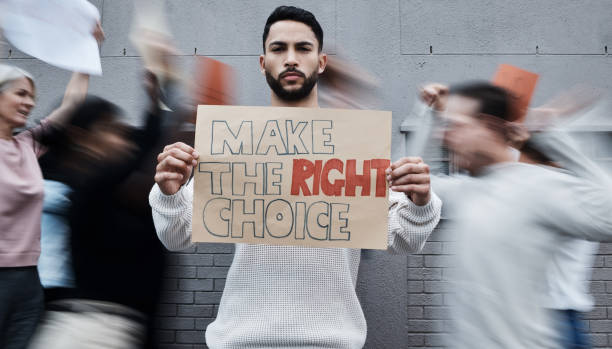 Shot of a young man holding a placard