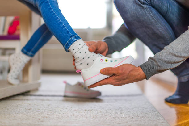 Single father is helping his daughter to get ready for school.