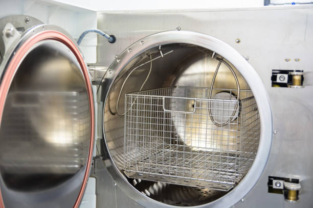 istock Medical sterilizer. Laboratory technician sterilizes medical instruments 1340880901