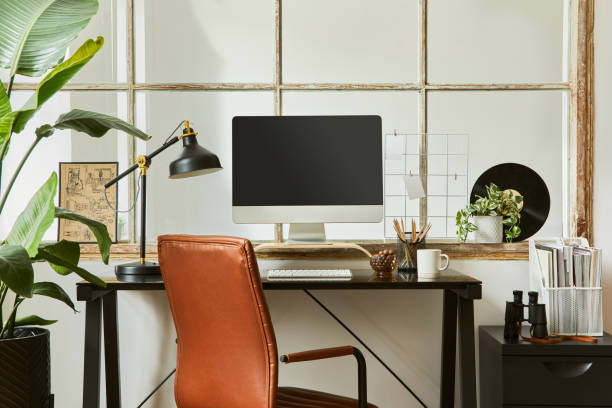 istock Creative composition of modern masculine home office workspace interior with black industrial desk, brown leather armchair, pc and stylish personal accessories. Template. 1340881651