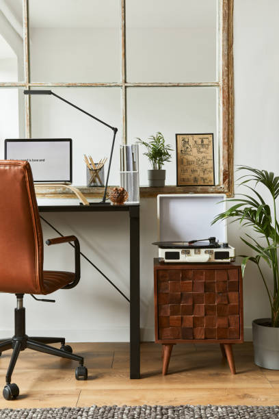 istock Creative composition of modern masculine home office workspace interior with black industrial desk, brown leather armchair, pc and stylish personal accessories. Template. 1340881657