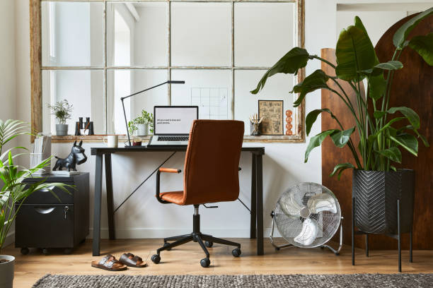 istock Creative composition of modern masculine home office workspace interior with black industrial desk, brown leather armchair, pc and stylish personal accessories. Template. 1340881659
