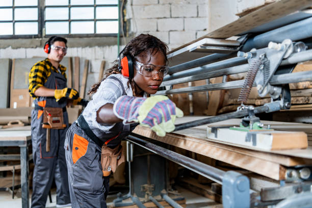 Manual worker working with wood in carpentry.