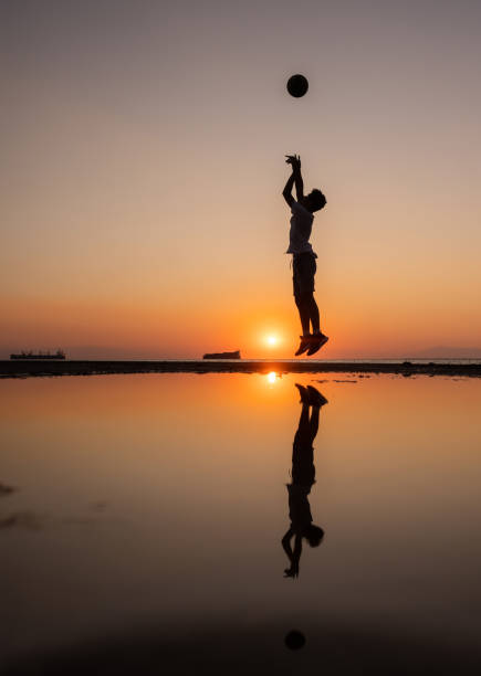 istock Young man practices basketball at sunset 1340881958