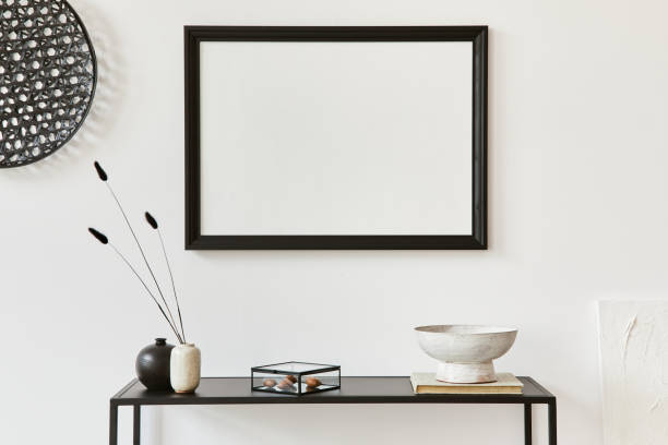 istock Minimalistic stylish composition of creative room interior design with mock up poster frame, metal shelf and personal accessories. Black and white concept. Template. 1340882120