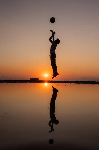 istock Young man practices basketball at sunset 1340882813