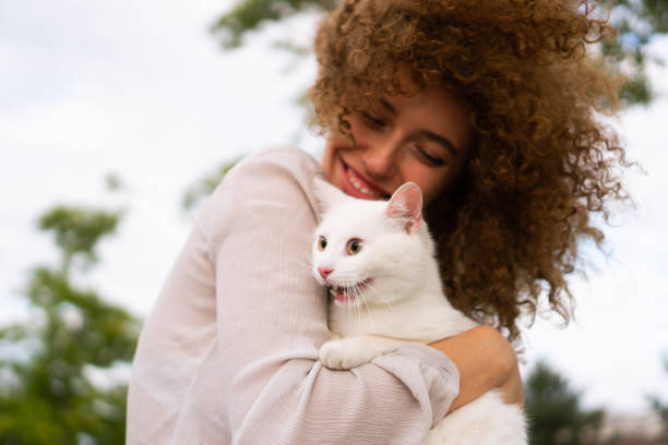 istock Beautiful girl and white cat 1340883054