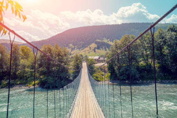 istock Wooden suspension bridge over a mountain river 1340883413