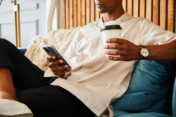 istock Young designer checking his phone during an office coffee break 1340883450