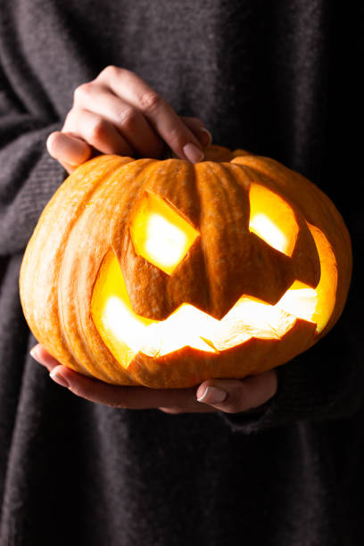 istock Big Haloween pampkin in woman's hands 1340883555