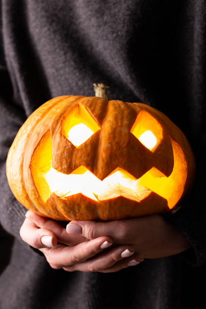istock Big Haloween pampkin in woman's hands 1340883574