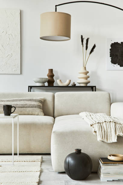istock Creative interior composition of cozy living room with mock up poster frame and structure painting, corner sofa, coffee table, textile and personal accessories. Scandinavian classic style. 1340883591