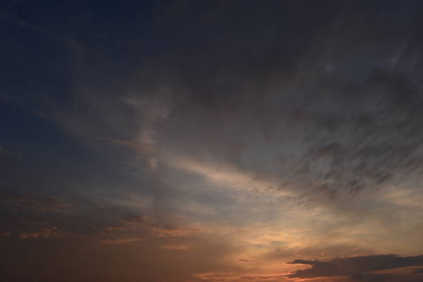 istock Cloudy sky in the sunset glow brightly lit orange color 1340884268
