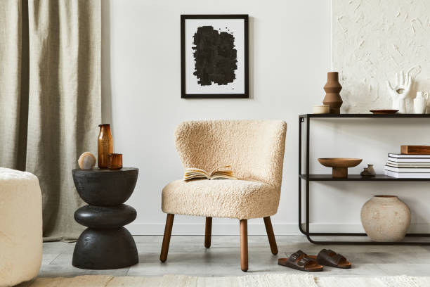 istock Creative composition of cozy living room interior design with mock up poster frame, fluffy armchair, coffee table, commode and personal accessories. Modern classic style. Template. 1340884433