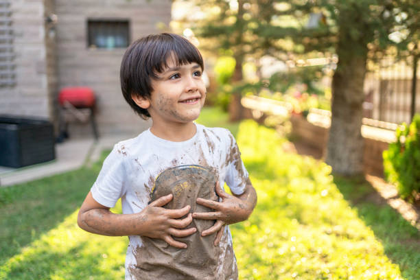 Child With Dirty Clothes İn Mud