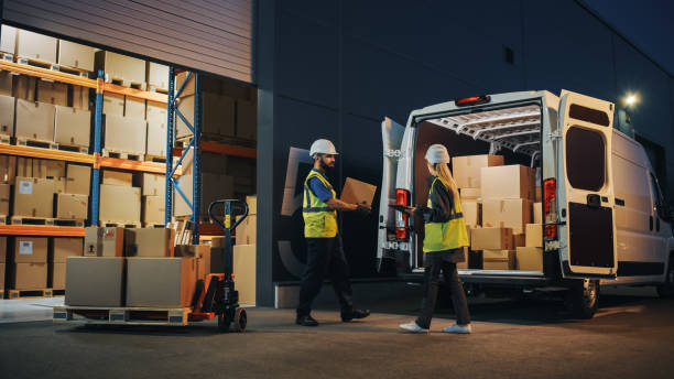 Outside of Logistics Retailer Warehouse With Female Manager Using Tablet Computer, Worker Loading Delivery Truck with Cardboard Boxes. Online Orders, Purchases, E-Commerce Goods, Supply. Outside of Logistics Retailer Warehouse With Female Manager Using Tablet Computer, Worker Loading Delivery Truck with Cardboard Boxes. Online Orders, Purchases, E-Commerce Goods, Supply. logistical stock pictures, royalty-free photos & images