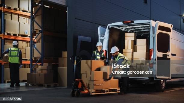 Outside Of Logistics Retail Warehouse With Inventory Manager Using Tablet Computer Talking To Worker Loading Delivery Truck With Cardboard Boxes Online Orders Food And Medicine Supply Ecommerce Stock Photo - Download Image Now