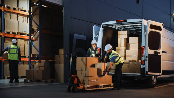 outside of logistics retail warehouse with inventory manager using tablet computer, talking to worker loading delivery truck with cardboard boxes, online orders, food and medicine supply, e-commerce - armazém de distribuição imagens e fotografias de stock