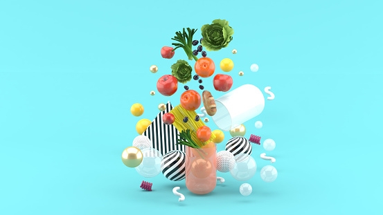 The food floats out of the capsule amidst colorful balls on the blue background.-3d render.