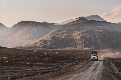 Car on road in the desert mountain of the Mongolia