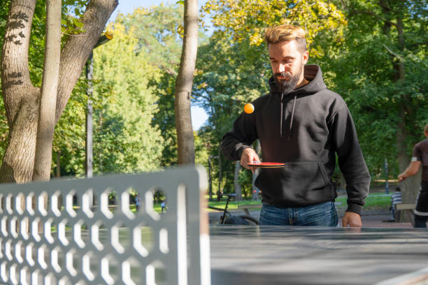 istock Playing table tennis outdoors on the open air sport ground. 1340888749