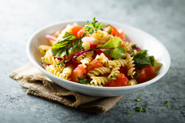 Pasta salad Healthy pasta salad with vegetables fusilli stock pictures, royalty-free photos & images