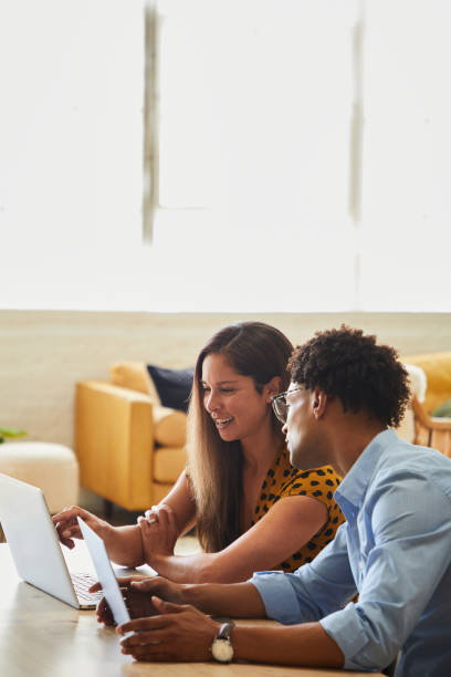 istock Smiling diverse businesspeople working together on a laptop in a modern office 1340889351