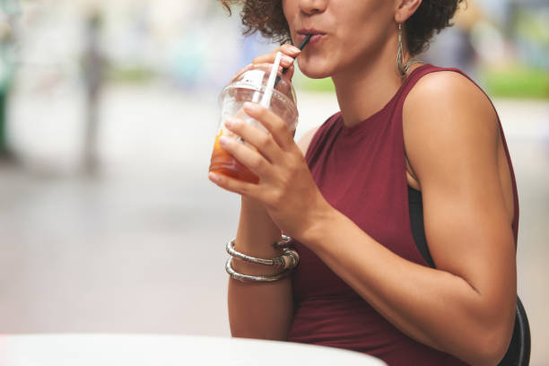 istock Woman Sipping Delicious Fruit Drink 1340890139